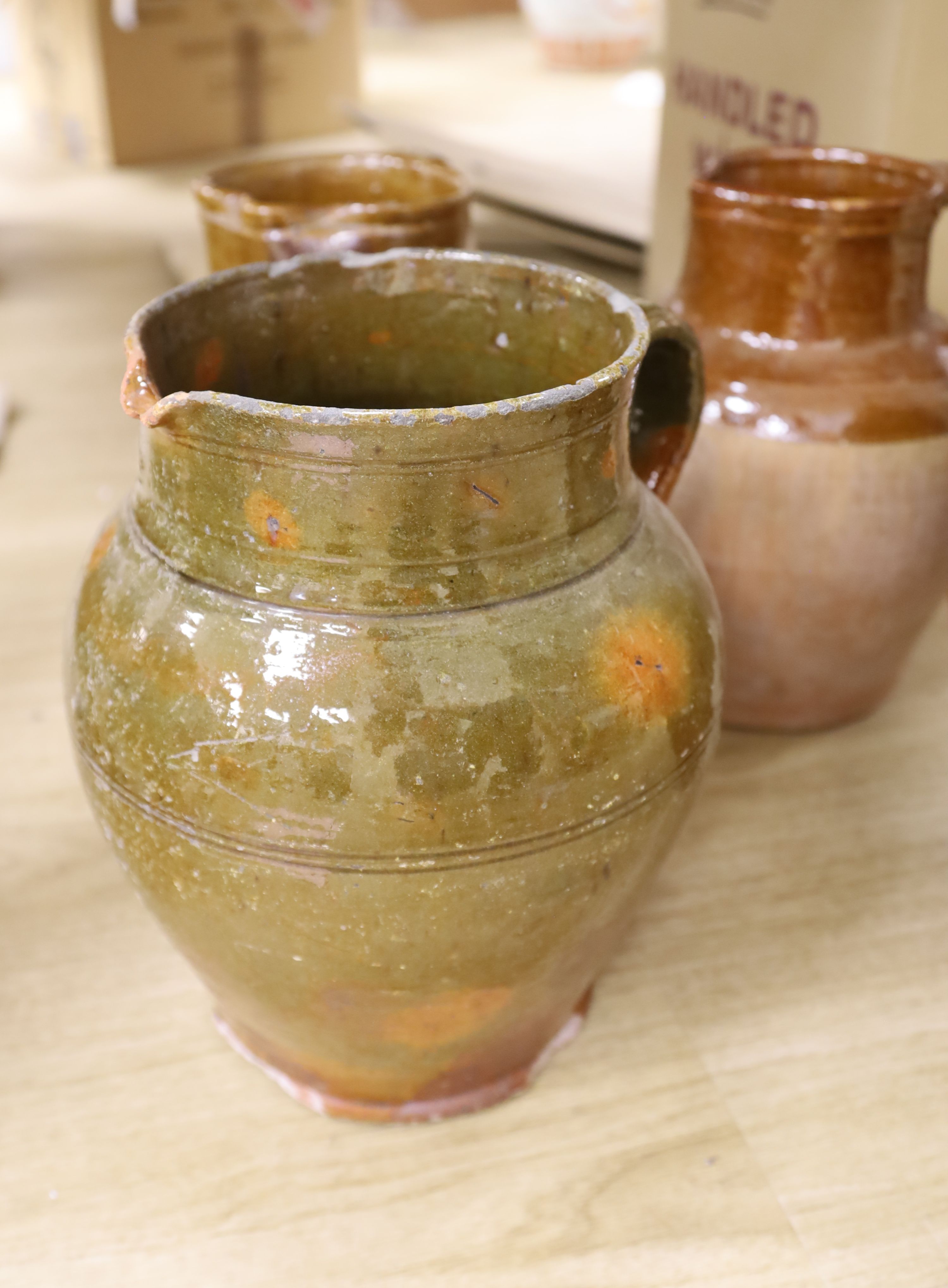 Four Sussex pottery jugs, tallest 34cm